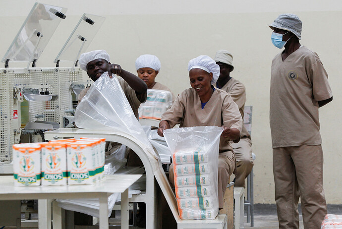 Workers package maize flour at the Capwell industries limited in Thika area of Kiambu County